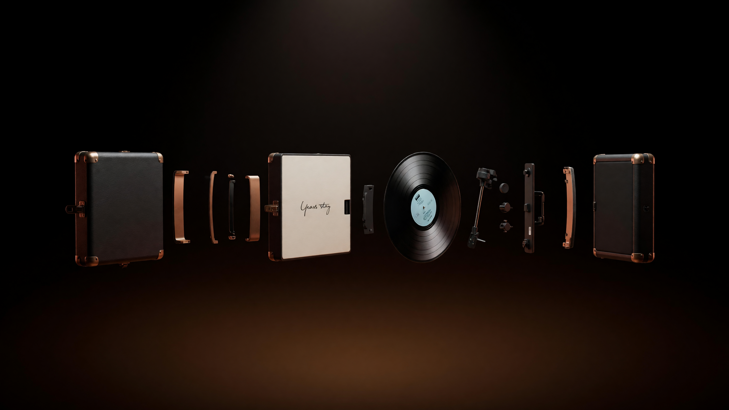 Exploded view of the Revolve case and turntable: leather shell, brass hardware, reinforced corner panel, vinyl record, tonearm mechanism and carry handle