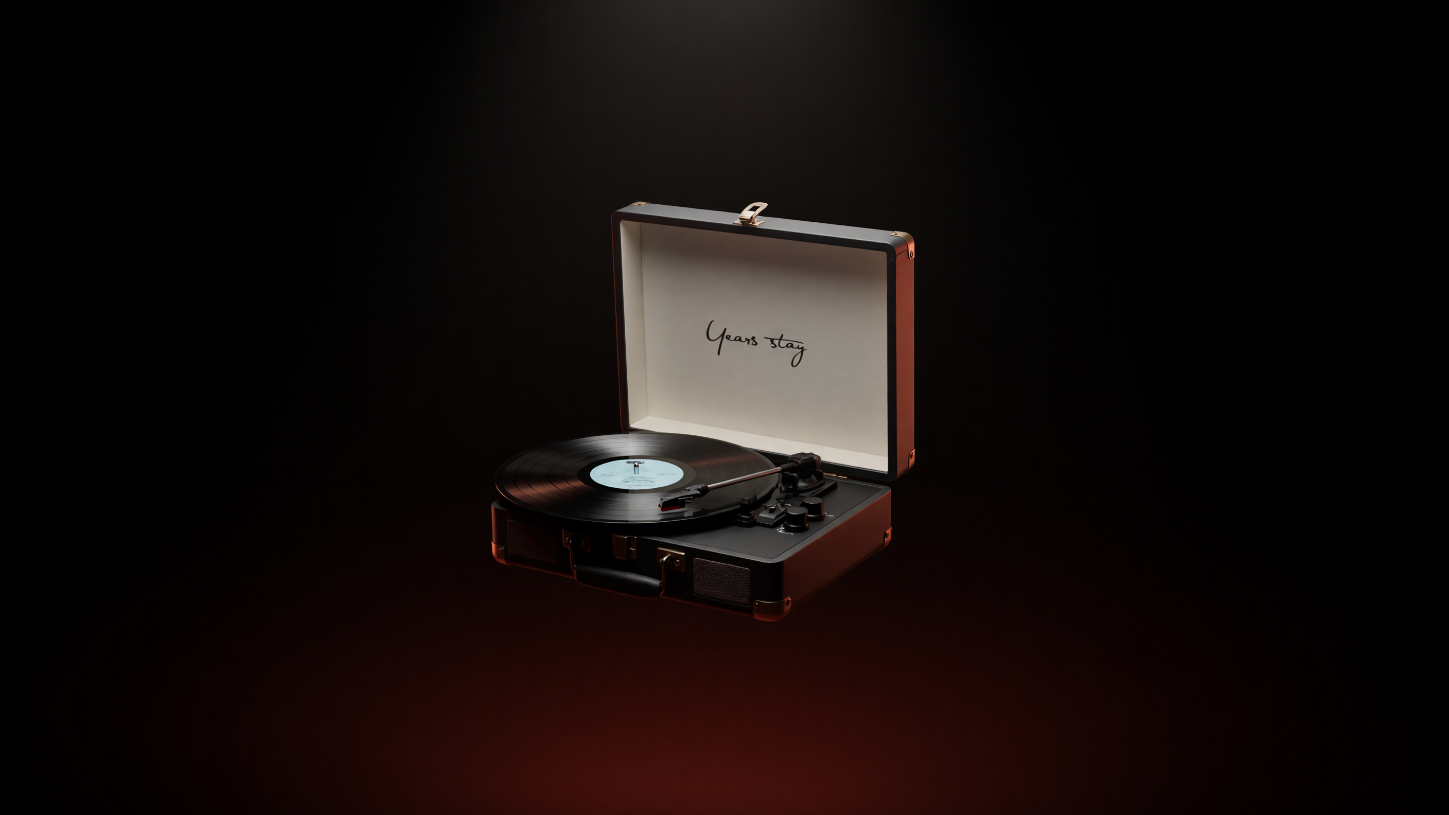 Revolve turntable in its open leather travel case, playing a record